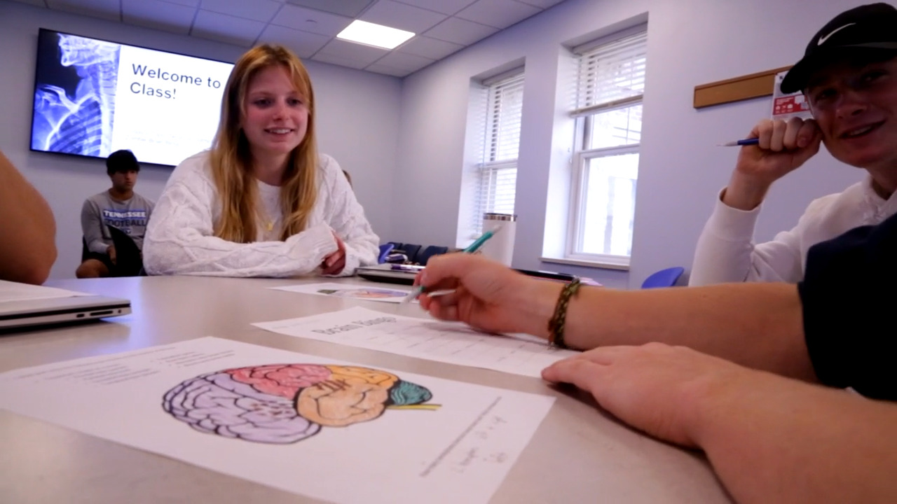 Students discuss neuroscience in a classroom