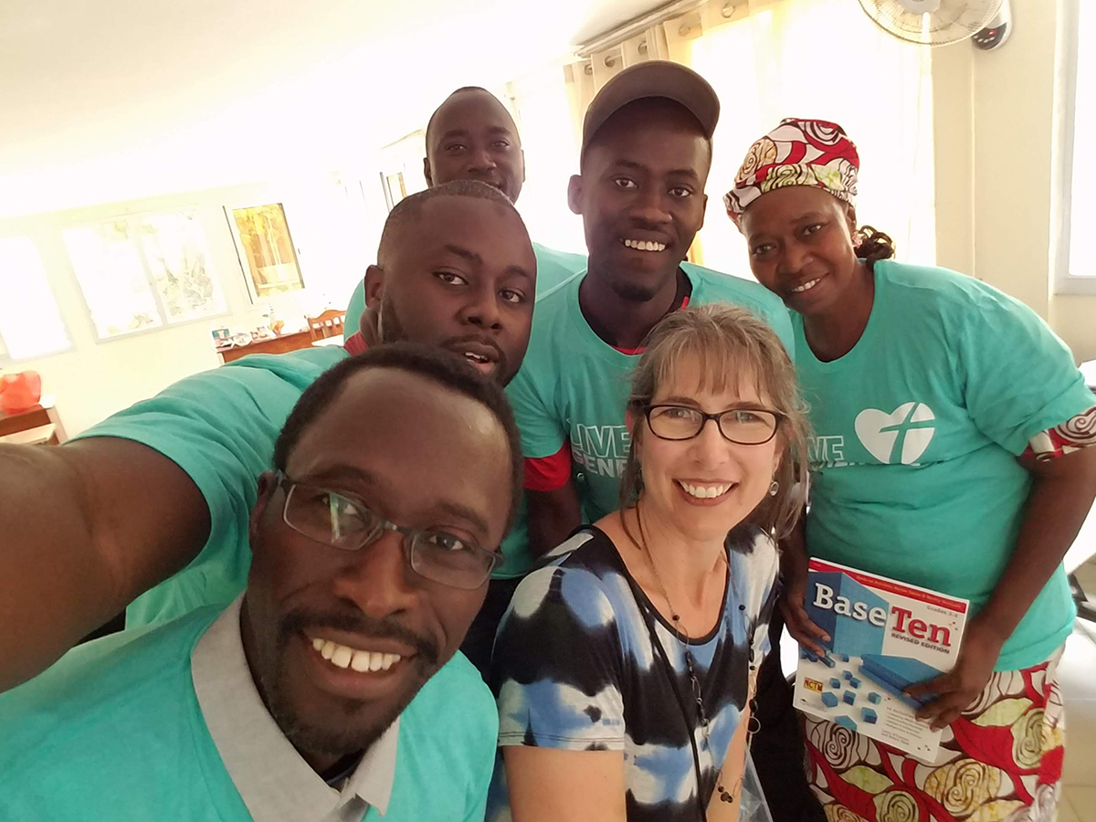 Dr. Michelle Homp at 2018 Afrimath Summer Program. Sharing Base-10 blocks (and t-shirts) provided by a Thrivent Action Grant