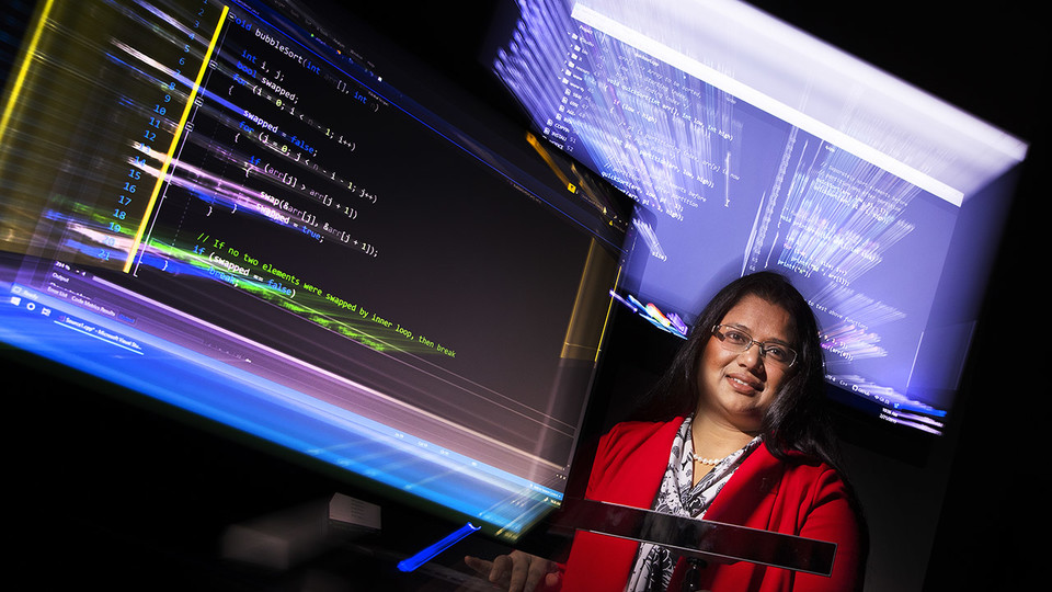 Bonita Sharif surrounded by computer screens 