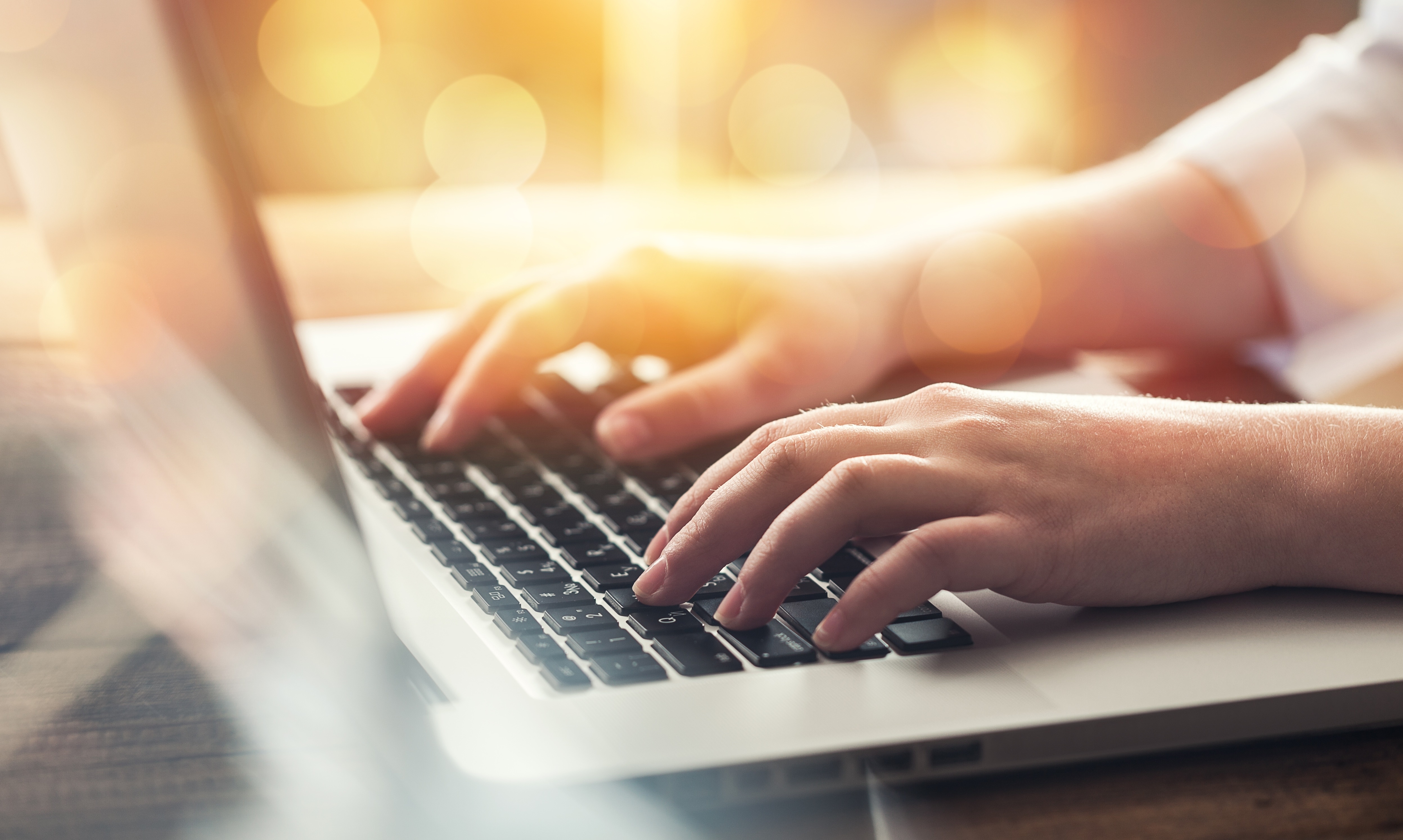 person typing on a laptop