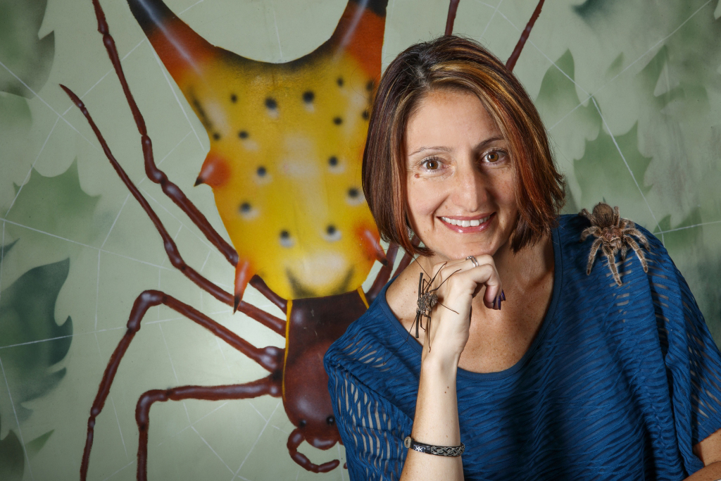 Eileen Hebets posed in front of picture of insect