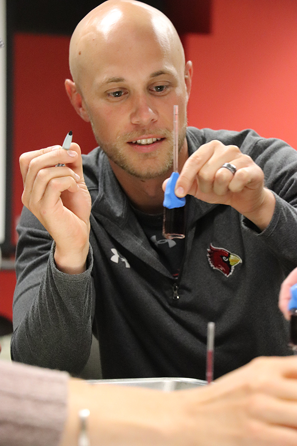 Drew Rische examines his thermometer in Math 807T in 2019. Credit: Stephanie Vendetti, CSMCE