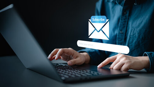 person typing on a compuer with an overlay that says subscribe
