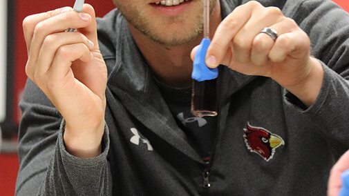 Drew Rische examines his thermometer in Math 807T in 2019. Credit: Stephanie Vendetti, CSMCE