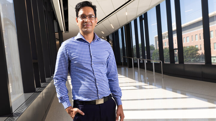 Nitesh Nama, assistant professor of mechanical and materials engineering at the University of Nebraska–Lincoln, poses in a hallway.