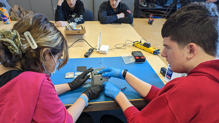 Students work on the satellite cube.