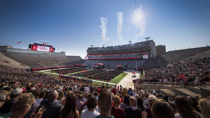 Onlookers watch as fireworks explode above Memorial Stadium following commencement ceremonies May 20, 2023.