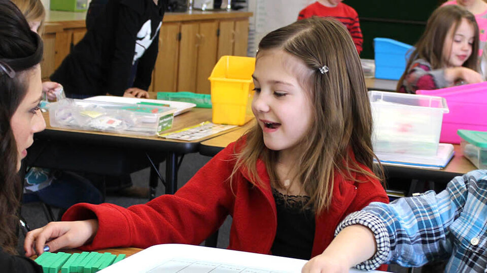 teacher interacting with elementary students