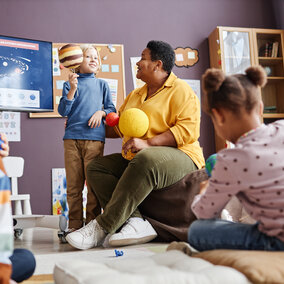 teacher talking to students about planets