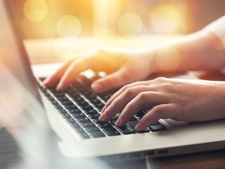 person typing on a laptop