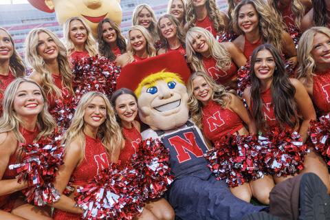 Herbie poses with the Scarlets dance team during the Sept. 16 home opener for Husker football.