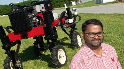 Santosh Pitla poses with the Flex-Ro autonomous tractor in June 2019.
