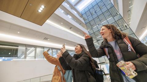 Engineering students (from left) Meghan Murphy, Fatima Pilar-Solis and Miriam Huss photograph friends as they go to their first class in Kiewit Hall on Jan. 22.
