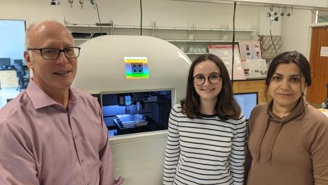 Joseph Turner is photographed with students Magdalene Peklo, a senior in mechanical engineering, and Faezeh Afshar-Hatam, a doctoral student in mechanical engineering, next to the nanoindenter that they used in this research. 