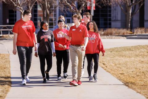 New Student Enrollment leaders walk campus during a warmer-than-normal February day.