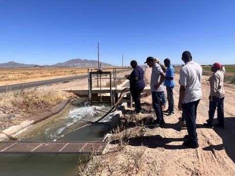 Students observe the water filter of an open canal in the Ak-Chin Indian Reservation in Arizona. 