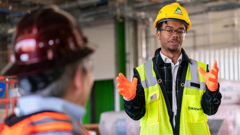Nebraska's Andre Tharp III gestures as he talks with Dean Lance C. Pérez during a recent tour of Kiewit Hall construction.